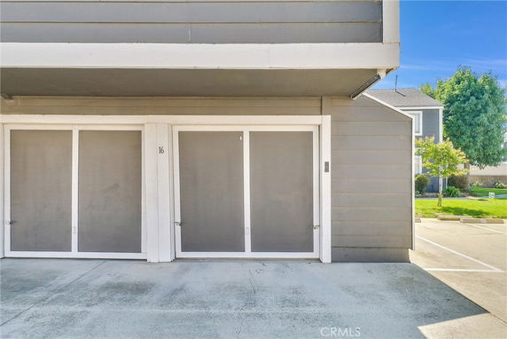 Covered parking area with multiple garage doors.
