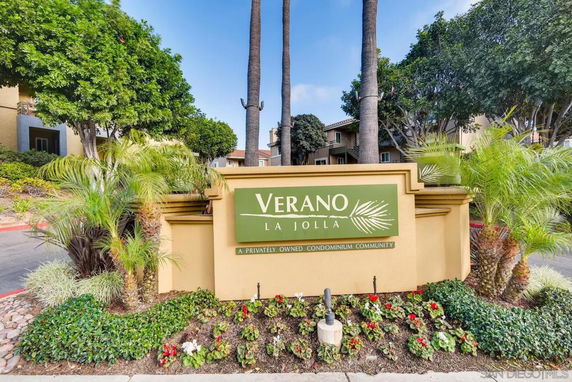 Entrance sign of Verano La Jolla condominium community with landscaped surroundings.
