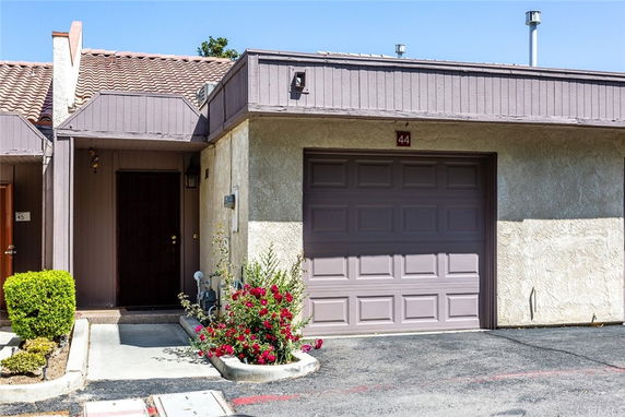 Front view of a house with a garage and entrance.