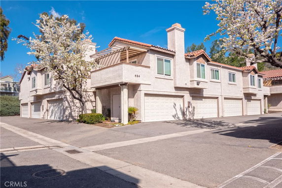 Front view of a two-story townhouse with garages