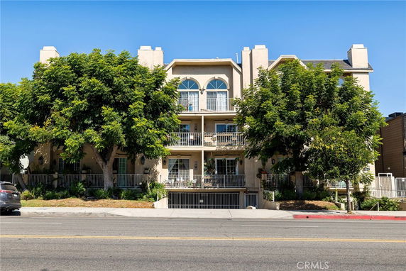 Front view of a multi-story residential building with balconies.