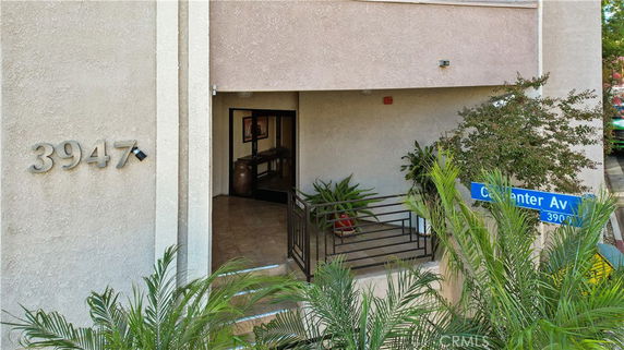 Front view of a building entrance with the number 3947 on the wall.