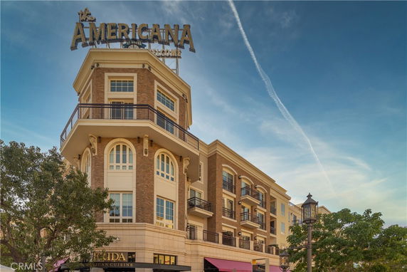 Front view of a multi-story building with a sign reading 'The Americana.'