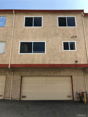Front view of a multi-story building with a garage door.