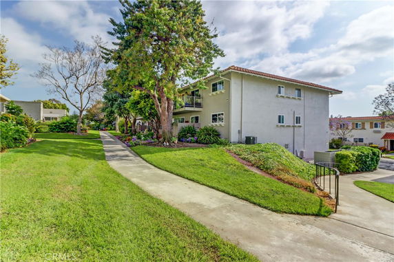 Front view of a two-story residential building with a landscaped garden.