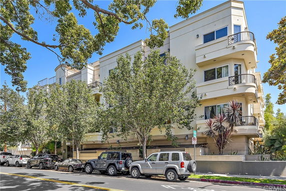 Front view of a multi-story residential building with balconies.