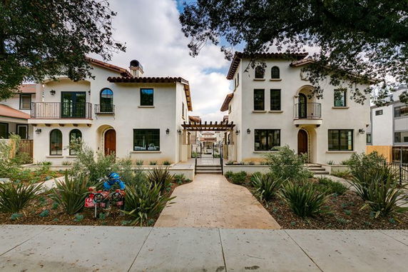 Front view of a two-story building with Mediterranean-style architecture.