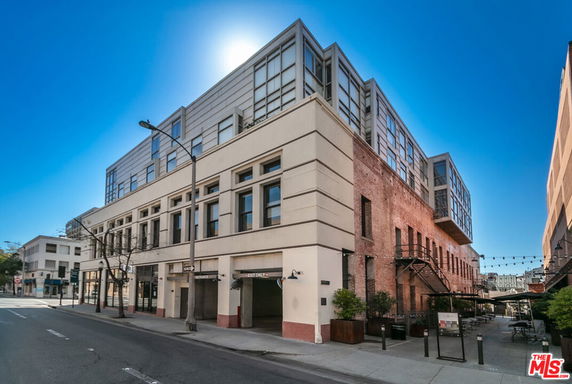 Front view of a multi-story building with a modern design and brick facade.