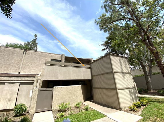 Front view of a two-story building with a simple design and a balcony.