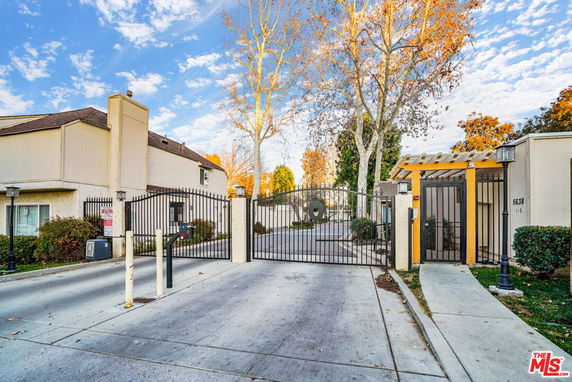 Front view of a gated residential complex entrance.