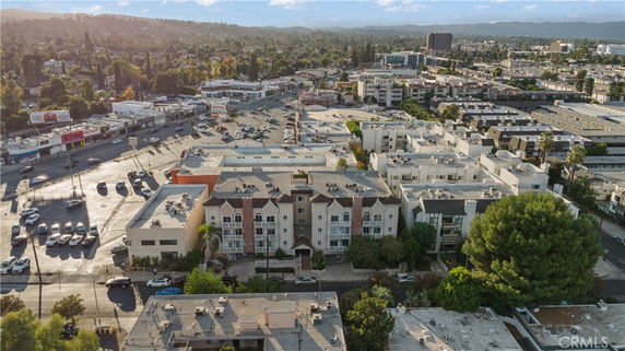 Aerial view of a residential and commercial area with multiple buildings and parking spaces.