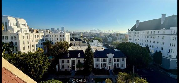 Panoramic view of cityscape with multiple multi-story buildings.