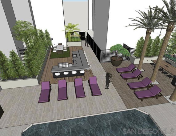 Outdoor area with a pool, lounge chairs, and a shaded seating area.