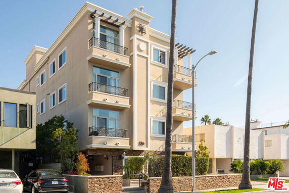 Front view of a multi-story residential building with balconies.