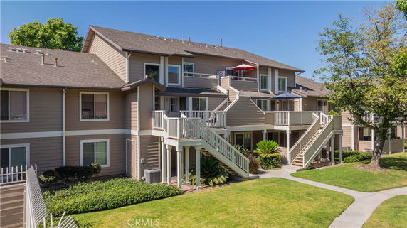 Front view of a multi-story residential building with external staircases.