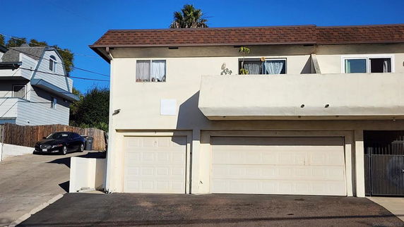 Front view of a two-story house with an attached garage.