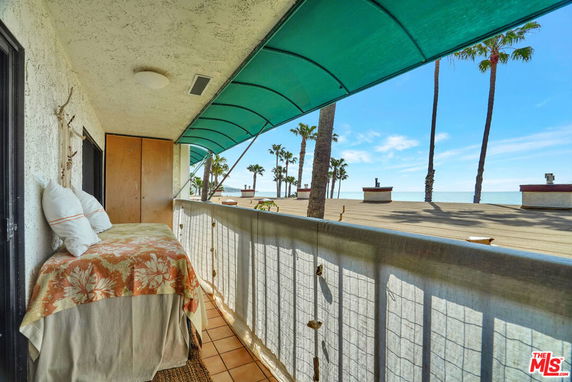 Balcony with a view of the ocean and palm trees