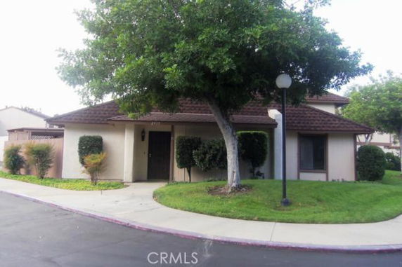 Front view of a single-story house with a sloped roof and a front yard.