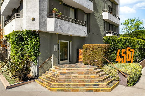 Front view of a multi-story building with steps leading to the entrance.