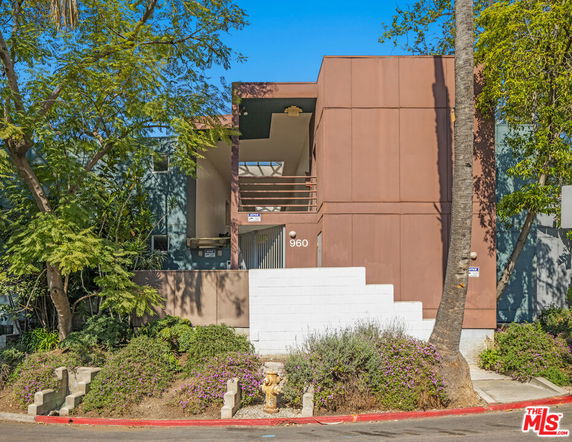 Front view of a modern multi-story building with a minimalist design.