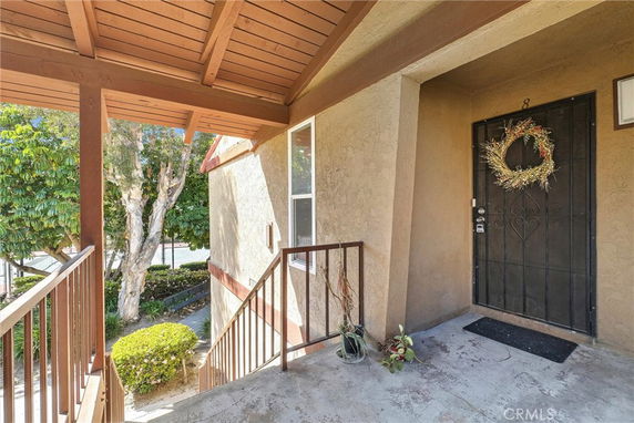 Entryway of a house with a decorative wreath on the front door.