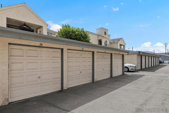 Outdoor parking area with numbered garage doors.