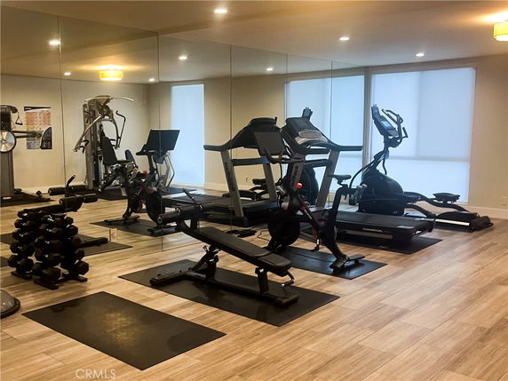 Indoor gym area with exercise equipment such as treadmills, weights, and bikes.