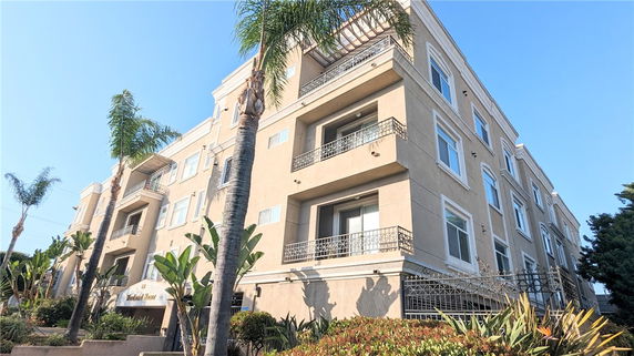 Front view of a multi-story apartment building with balconies.