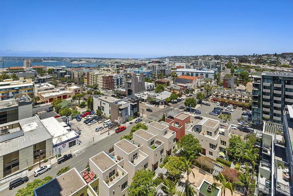 Panoramic view of a cityscape with buildings and streets seen from a high vantage point.