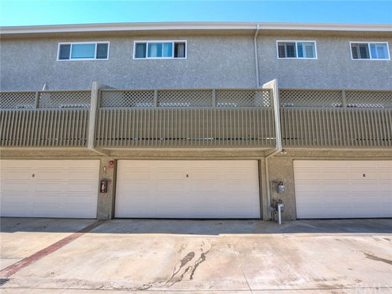 Front view of a building with garage doors on the ground level.