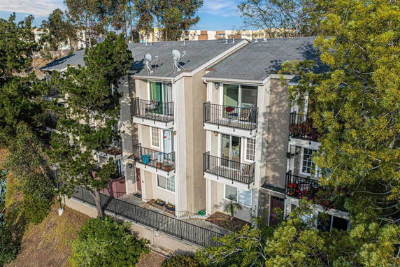 Front view of a multi-story apartment building with balconies.