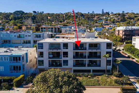 Front view of a multi-story residential building with balconies.