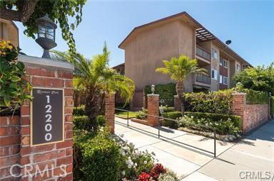 Front view of a three-story residential building with a brick entrance.