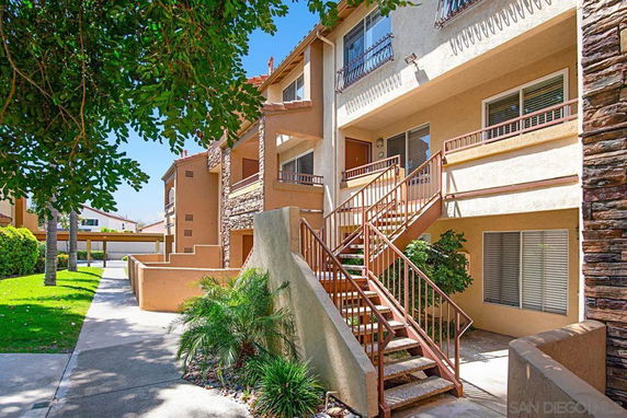 Front view of a multi-story residential building with exterior stairs.