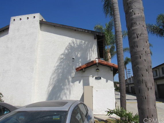 Side view of a two-story building with a slanted roof.