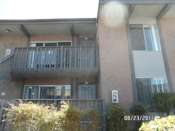 Front view of a two-story apartment building with balconies.