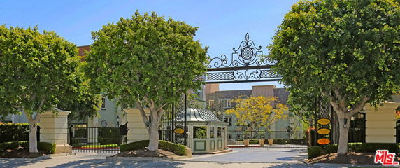 Front view of a residential complex with a decorative entrance gate.