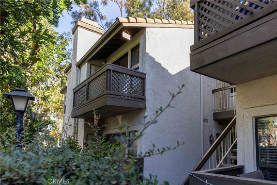 Elevation view of a two-story residential building with balconies.