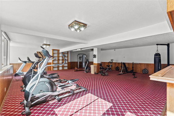 Indoor gym area with exercise equipment and a punching bag