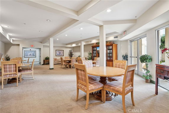 Interior view of a clubhouse area with tables and chairs for social gatherings.