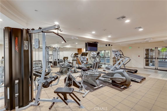 Indoor gym with various exercise equipment including treadmills and weight machines.
