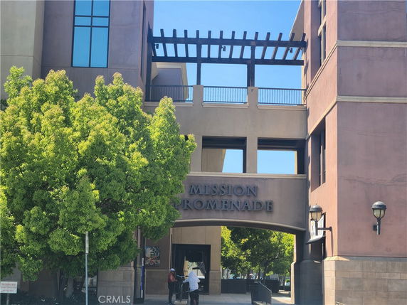 Front view of a building entrance with an archway labeled 'MISSION PROMENADE'.