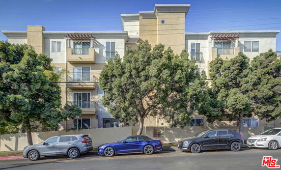 Front view of a multi-story apartment building with balconies.