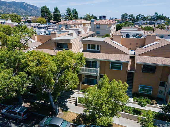 Front view of a multi-story residential building with multiple entrances.