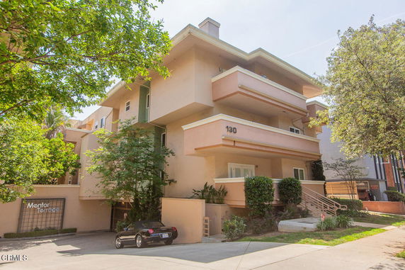 Front view of a multi-story apartment building with balconies.