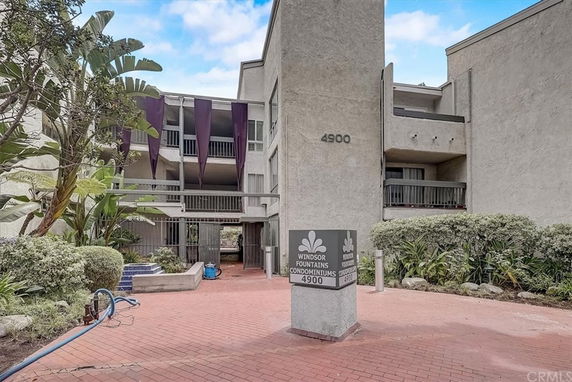 Front view of a multi-story condominium building with balconies.