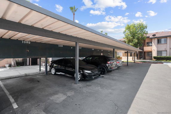 Covered parking area with cars.