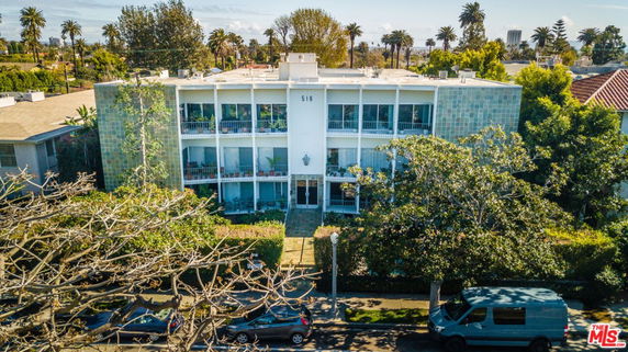 Front view of a multi-story building with balconies.