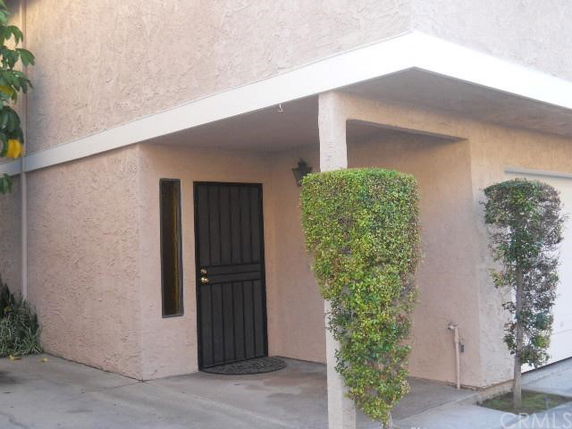 Front view of a building with a covered entrance and a door.