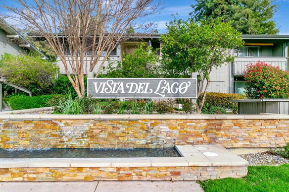 Front view of a residential building with a sign that reads 'Vista Del Lago.'